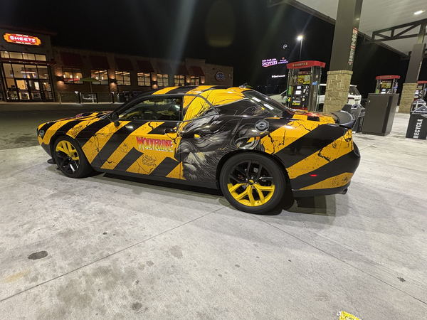 Dodge Challenger with a custom printed graphic wrap and yellow wheels