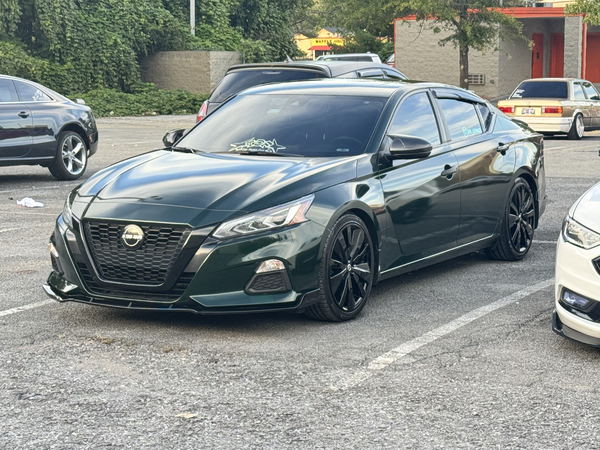 Nissan Altima wrapped in a deep gloss green color change