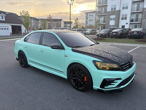 Volkswagen Passat in a mint green wrap with forged carbon hood and roof